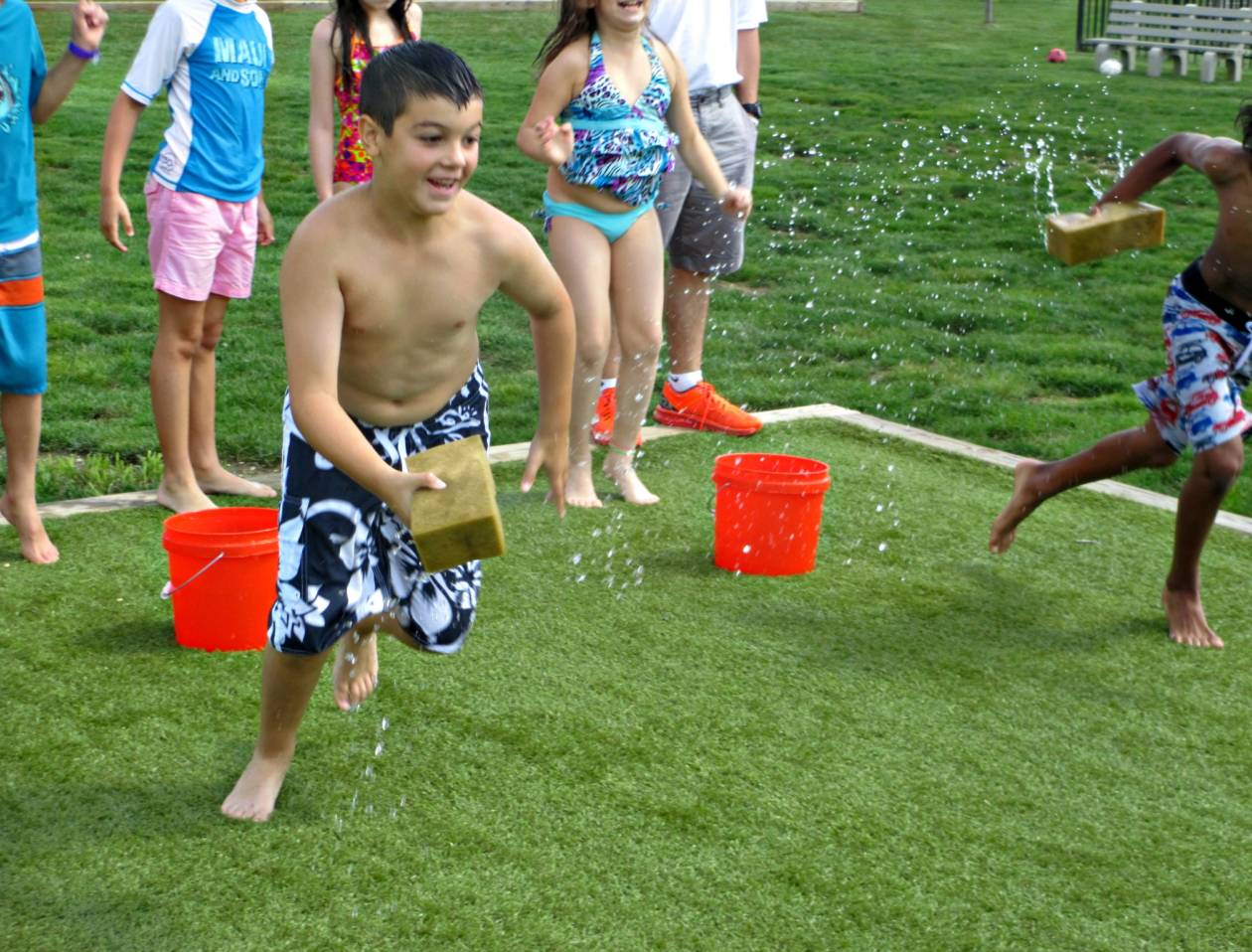 Kids playing tag with wet sponges