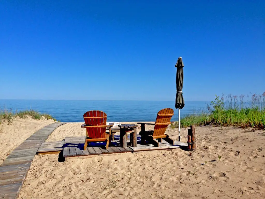 Chairs and umbrella sitting on the beach at Lake Huron
