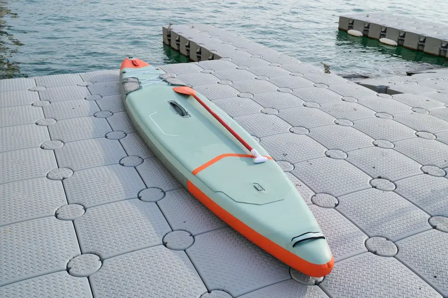 Stand up paddle board on a plastic modular floating dock